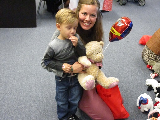 A mother and her son are getting a Teddy Bear